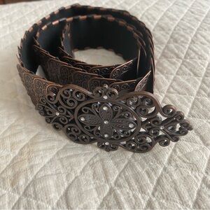 Copper-colored metal belt with elastic band and intricate bedazzled buckle